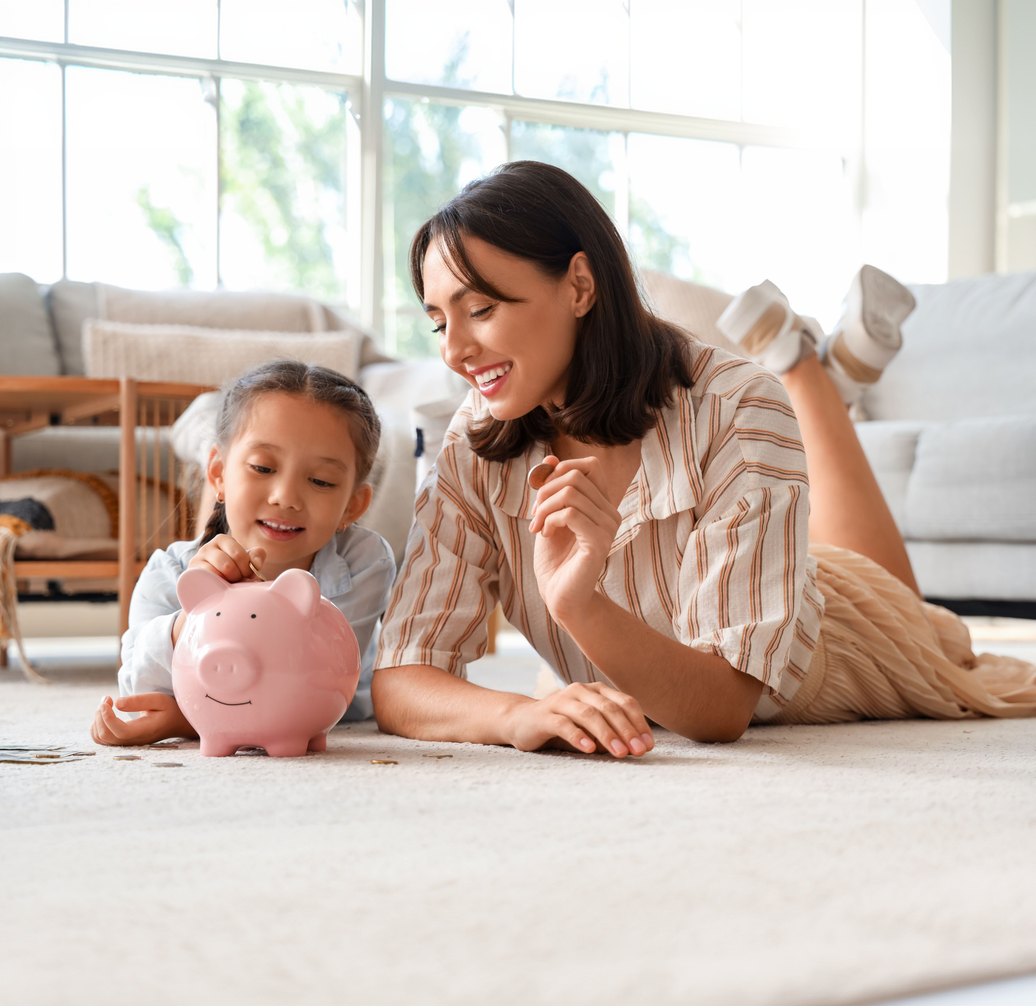 Parent and child counting coins together to learn the basics of personal finance